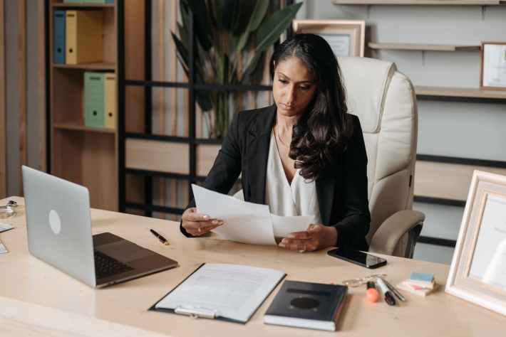 Woman Working at the Desk in a Law Firm